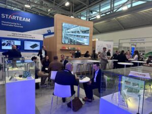 People milling around, chatting, at the Starteam stall at the Electronica exhibition in 2024