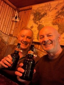 Two men enjoying a bottle of beer