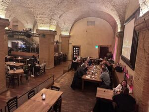 A group of people having a meal at a long table in a Munich restaurant